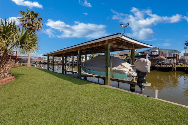 view of dock with boat lift, a yard, and a water view