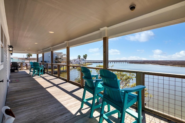 wooden deck featuring a water view