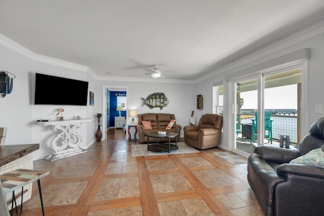 living area featuring crown molding, baseboards, a ceiling fan, and a textured ceiling