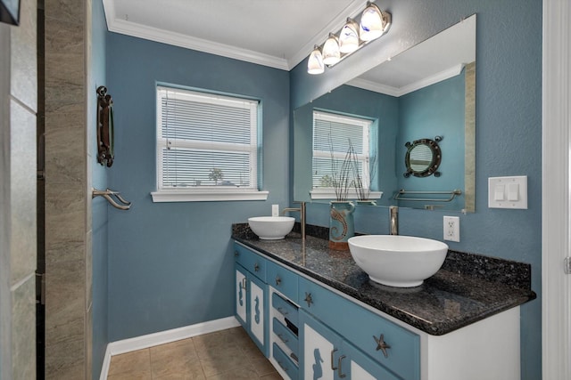 full bath featuring double vanity, baseboards, a sink, and crown molding