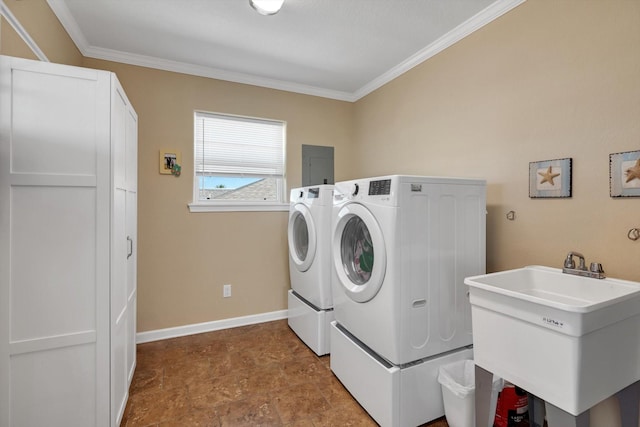 laundry room featuring baseboards, washer and dryer, a sink, laundry area, and crown molding