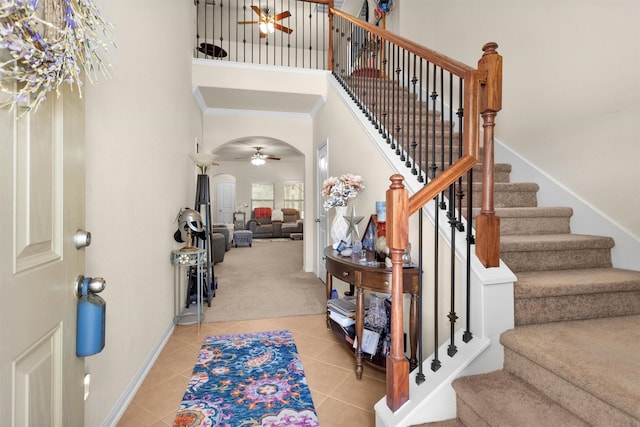 5305 Weeping Bow, Willis, TX 77378 - foyer featuring light carpet, a high ceiling, light tile patterned floors, and a ceiling fan