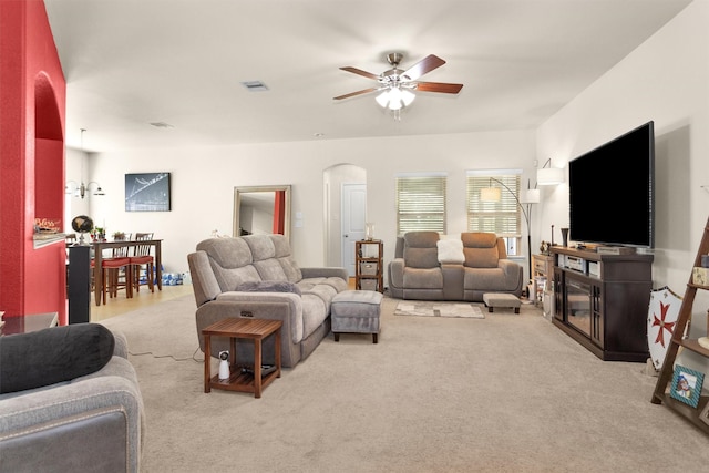 5305 Weeping Bow, Willis, TX 77378 - living room featuring arched walkways, ceiling fan, carpet flooring, and visible vents