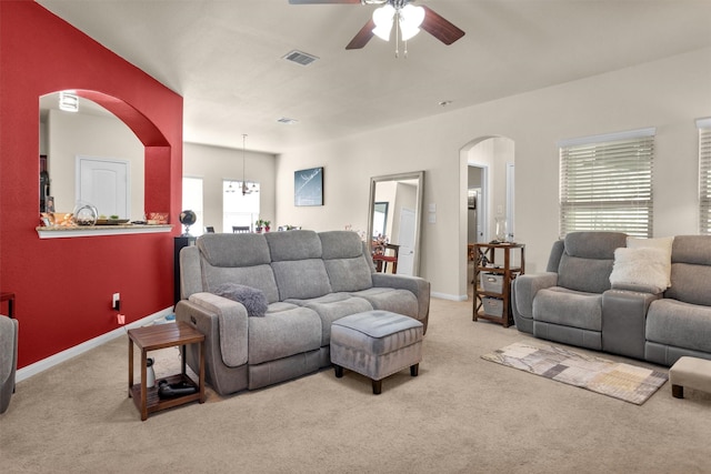 5305 Weeping Bow, Willis, TX 77378 - living area featuring visible vents, ceiling fan, arched walkways, and carpet