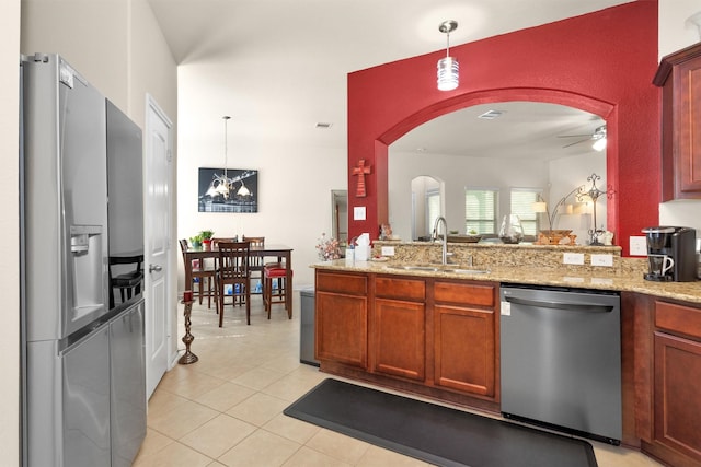 5305 Weeping Bow, Willis, TX 77378 - kitchen featuring arched walkways, a sink, ceiling fan, appliances with stainless steel finishes, and pendant lighting