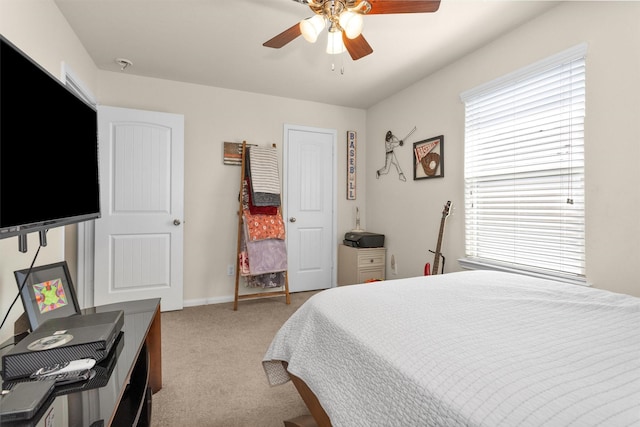 5305 Weeping Bow, Willis, TX 77378 - bedroom with light carpet, baseboards, multiple windows, and a ceiling fan