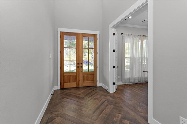 entrance foyer with baseboards, ornamental molding, french doors, and visible vents