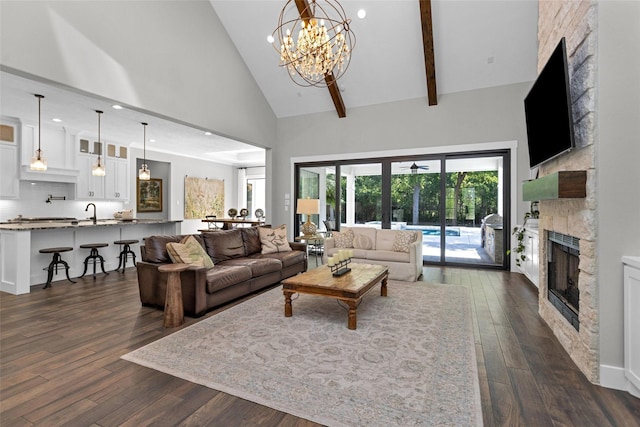 living area with a chandelier, recessed lighting, dark wood-style floors, a fireplace, and high vaulted ceiling
