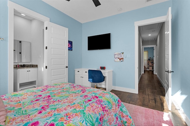 bedroom with a sink, attic access, ceiling fan, baseboards, and dark wood-style flooring