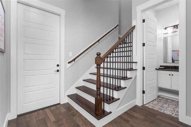 stairway featuring baseboards and wood finished floors