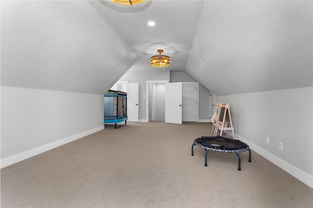 bonus room featuring vaulted ceiling, baseboards, carpet floors, and a textured ceiling