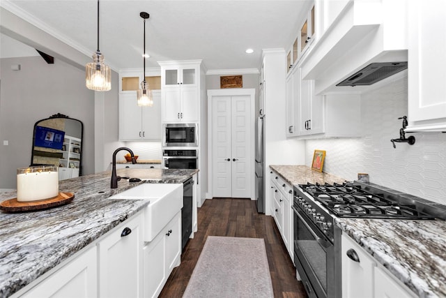 kitchen with glass insert cabinets, wall chimney exhaust hood, white cabinetry, and black appliances