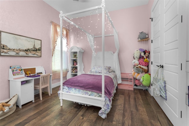 bedroom featuring baseboards and wood finished floors