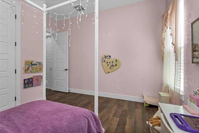 bedroom featuring baseboards and wood finished floors