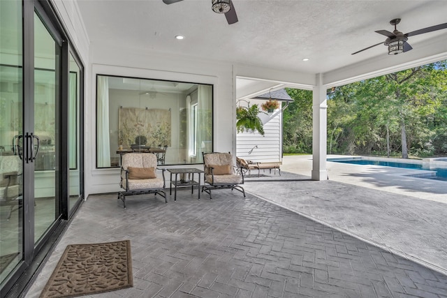 view of patio with a ceiling fan and an outdoor pool