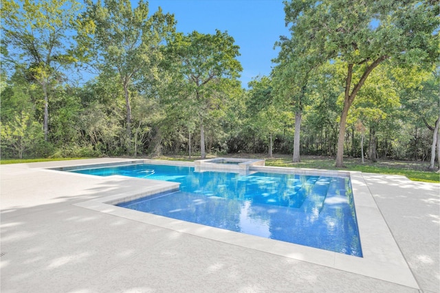 view of pool featuring a patio area and a pool with connected hot tub
