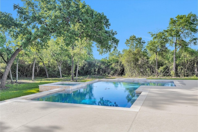 outdoor pool with a patio and an in ground hot tub