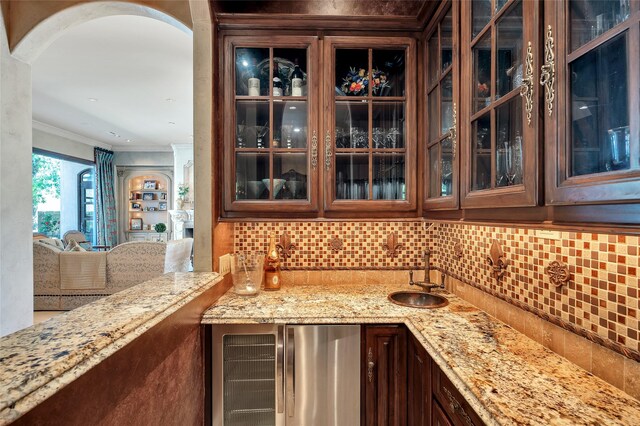 5530 Tilbury Dr, Houston, TX 77056 - bar with decorative backsplash, wet bar, crown molding, a sink, and beverage cooler