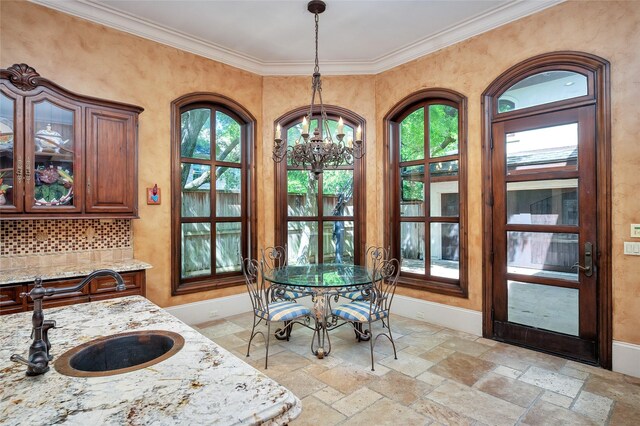 5530 Tilbury Dr, Houston, TX 77056 - dining space with crown molding, plenty of natural light, stone tile flooring, and a chandelier