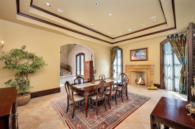 5530 Tilbury Dr, Houston, TX 77056 - dining area featuring arched walkways, light tile patterned flooring, a wealth of natural light, and a raised ceiling
