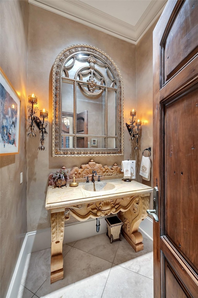 bathroom with tile patterned floors, a sink, and crown molding