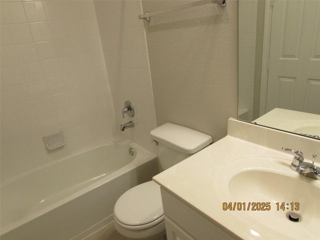 bathroom featuring toilet, vanity, and tub / shower combination