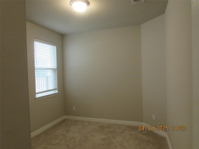 unfurnished room with light carpet and baseboards