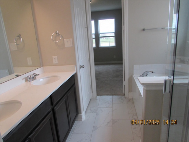 full bathroom featuring a sink, a bath, double vanity, and marble finish floor