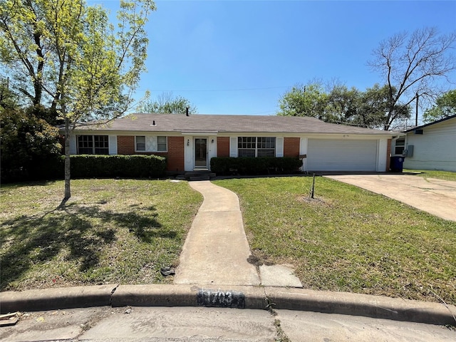 ranch-style home with brick siding, an attached garage, a front lawn, and concrete driveway