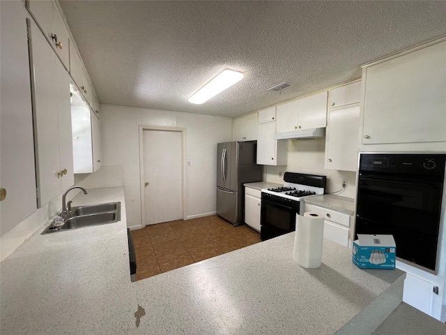 kitchen with dobule oven black, freestanding refrigerator, gas range, under cabinet range hood, and a sink