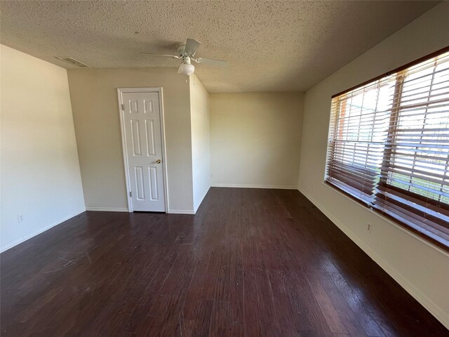 empty room featuring baseboards, a textured ceiling, a ceiling fan, and wood finished floors