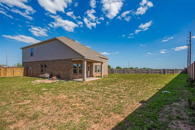 108 Solana Point Dr, Katy, TX 77493 - back of property featuring a yard, a fenced backyard, a patio area, and brick siding