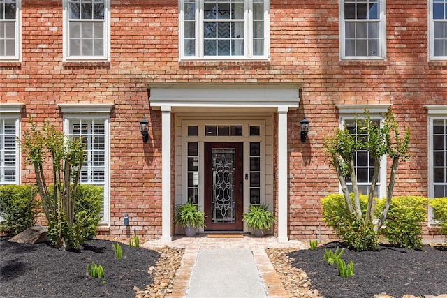 property entrance featuring brick siding