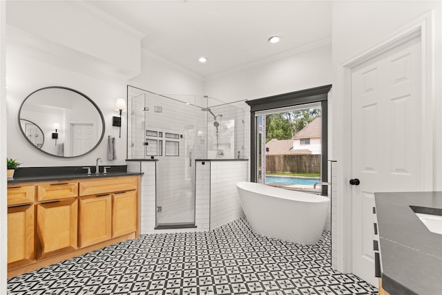 full bathroom with vanity, a stall shower, crown molding, a soaking tub, and recessed lighting
