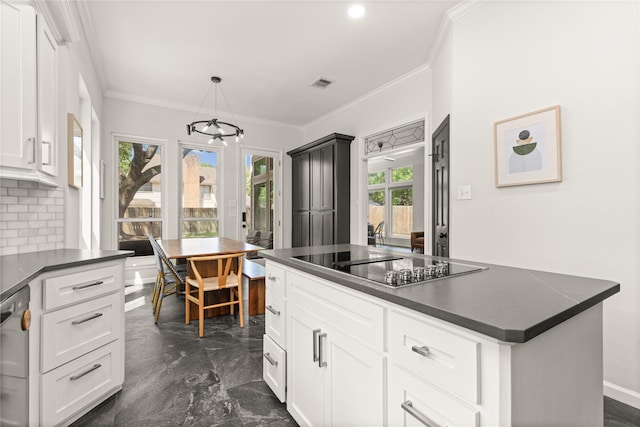 kitchen with black electric stovetop, dark countertops, a chandelier, ornamental molding, and backsplash