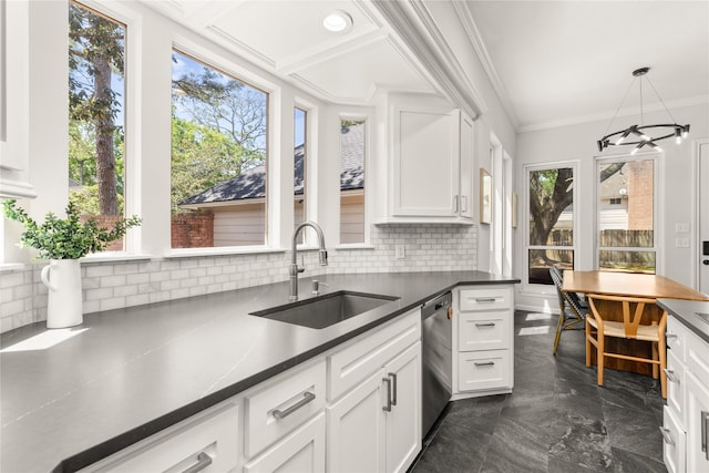 kitchen with a sink, stainless steel dishwasher, dark countertops, tasteful backsplash, and ornamental molding
