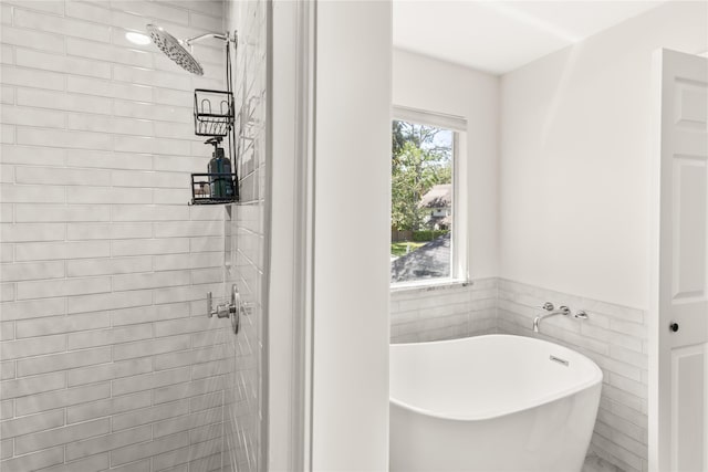 full bathroom featuring tiled shower and a soaking tub