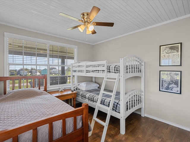 bedroom featuring a ceiling fan, wood finished floors, baseboards, and ornamental molding
