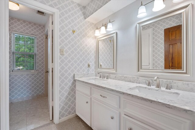 7914 Rio Crystal Dr, Houston, TX 77095 - bathroom with double vanity, wallpapered walls, and baseboards
