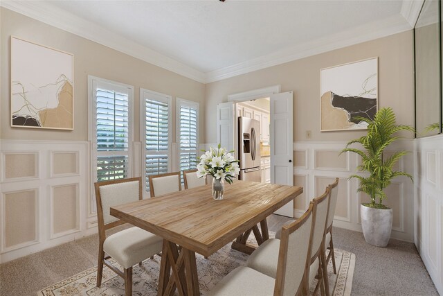 7914 Rio Crystal Dr, Houston, TX 77095 - dining space featuring a decorative wall, light carpet, crown molding, and wainscoting