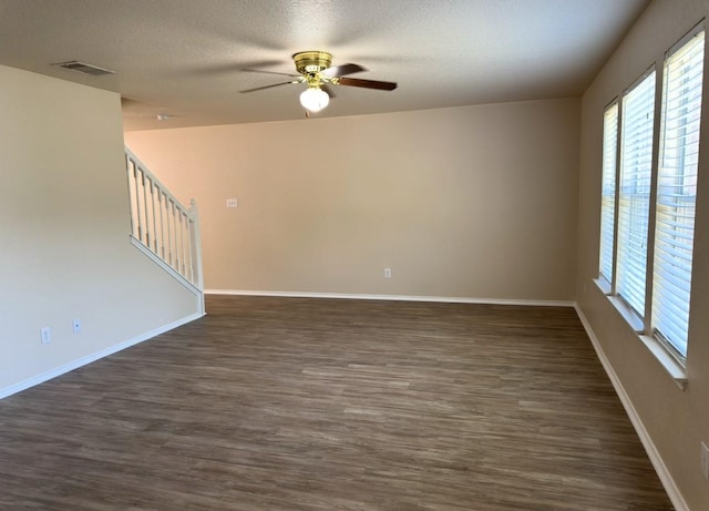 619 Mathis Mdw, San Antonio, TX 78251 - spare room featuring a ceiling fan, plenty of natural light, dark wood-type flooring, a textured ceiling, and stairway