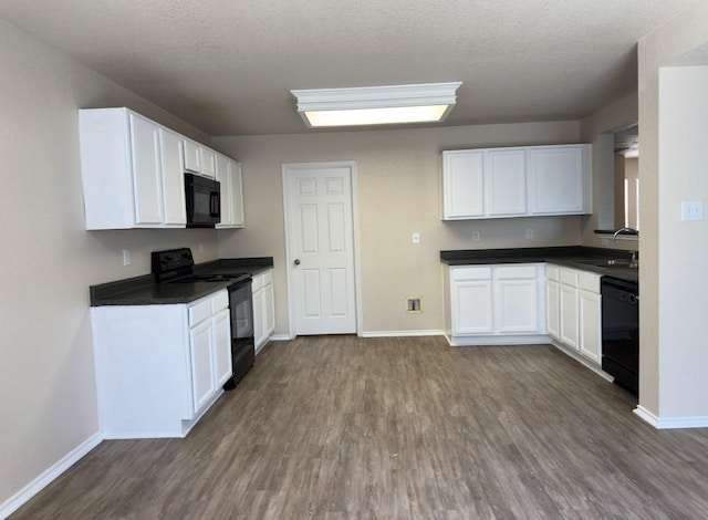 619 Mathis Mdw, San Antonio, TX 78251 - kitchen featuring black appliances, dark wood-type flooring, baseboards, dark countertops, and a sink