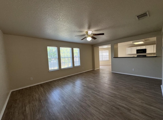 619 Mathis Mdw, San Antonio, TX 78251 - unfurnished living room featuring ceiling fan, dark wood-style flooring, a textured ceiling, and baseboards