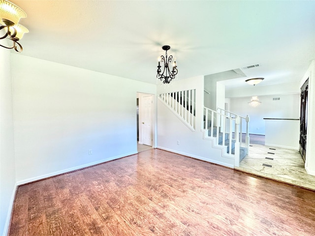 7914 Oakington Dr, Houston, TX 77071 - unfurnished living room with a chandelier, wood finished floors, stairway, and baseboards
