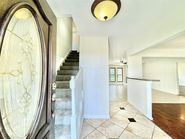 7914 Oakington Dr, Houston, TX 77071 - entrance foyer featuring light tile patterned flooring, stairs, ceiling fan, and baseboards