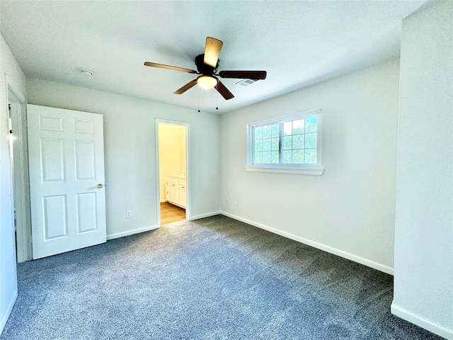 7914 Oakington Dr, Houston, TX 77071 - unfurnished bedroom with dark colored carpet, baseboards, and ensuite bathroom