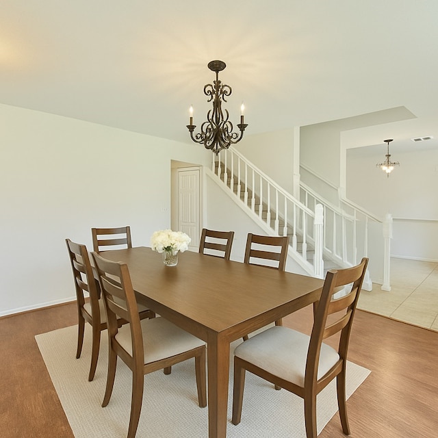 7914 Oakington Dr, Houston, TX 77071 - dining space featuring a chandelier, stairs, and baseboards