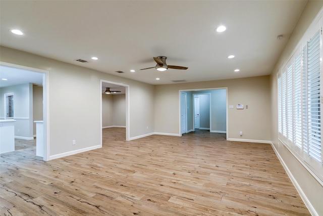 spare room featuring a ceiling fan, recessed lighting, baseboards, visible vents, and light wood-style floors