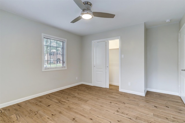 unfurnished bedroom with light wood-style floors, baseboards, and ceiling fan