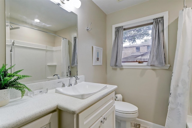 bathroom with toilet, baseboards, vanity, and curtained shower